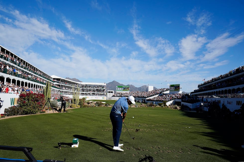 Scottie Scheffler tees off on the 16th hole during the final round of the Phoenix Open golf...