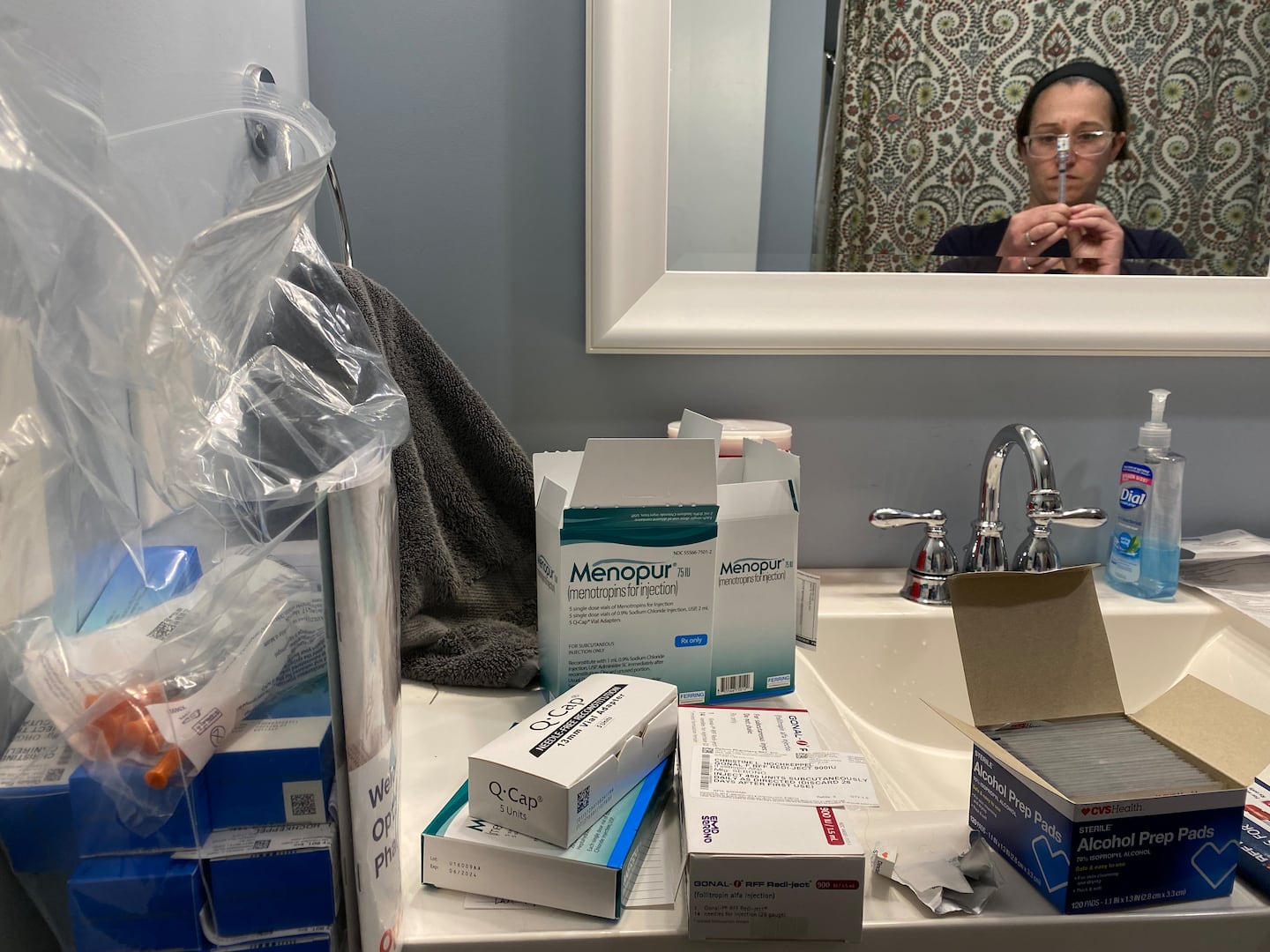 Christine Hochkeppel’s wife, Stephanie Soares, drew Menopur into a syringe next to the next stockpile of drugs on March 21, 2023.