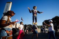 Attendees walk past Big Tex at the State Fair of Texas on Tuesday, Oct. 7, 2025, in Dallas....