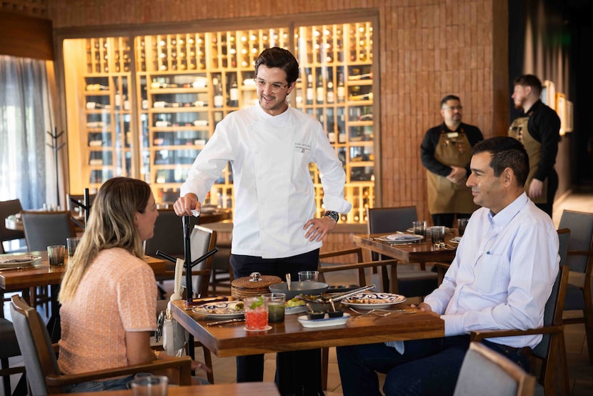 Chef Rodrigo Cárdenas (center) speaks to guests Liliana Diego (left) and Homero Amezcua from...