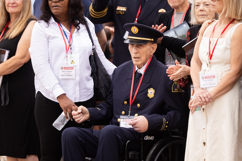 DRFFA Chaplain Denny Burris watches as the wreath is laid in front of the Dallas...