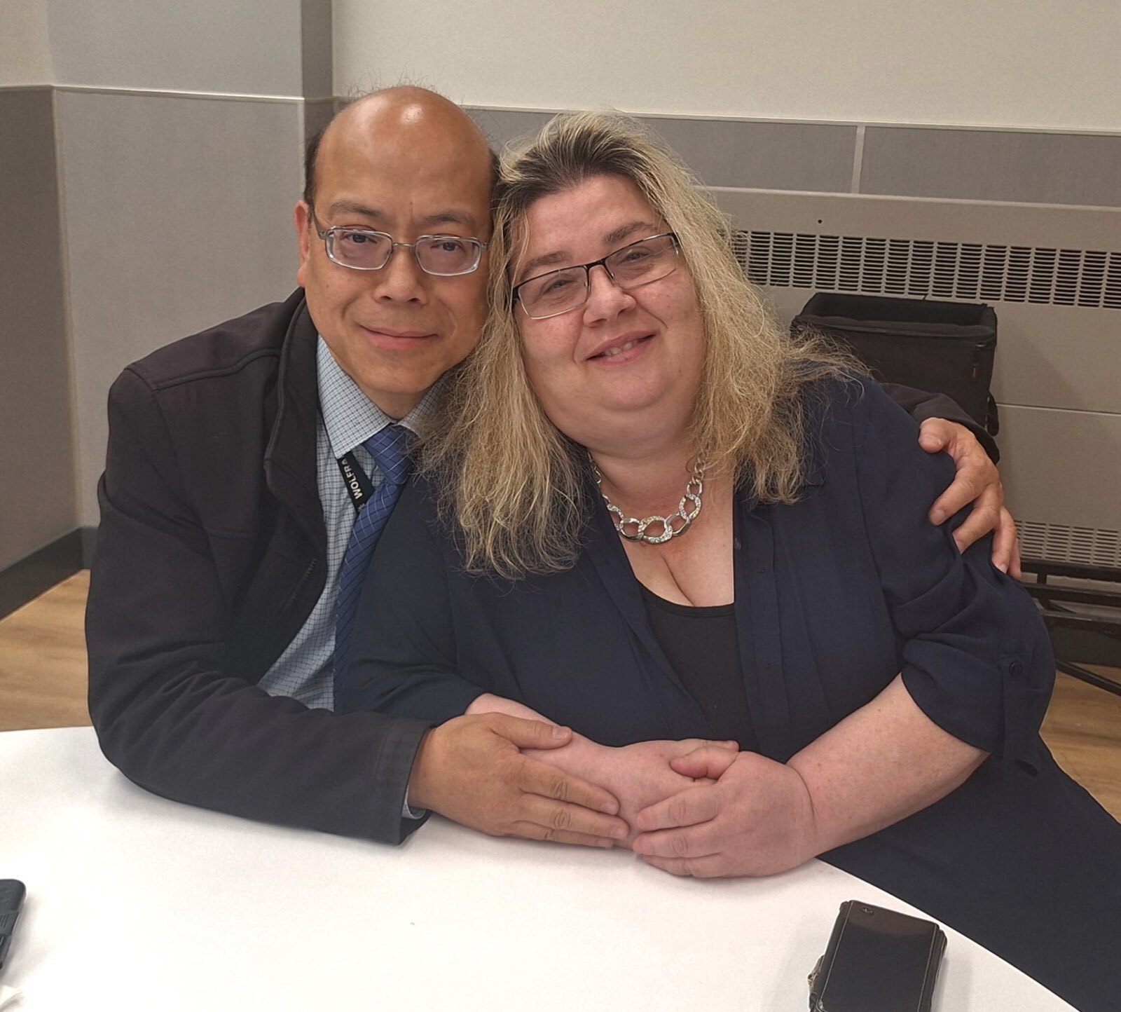 Phil Wong, left, and Alicia Vaichunas, right, both work for incumbent Council Member Bob Holden.