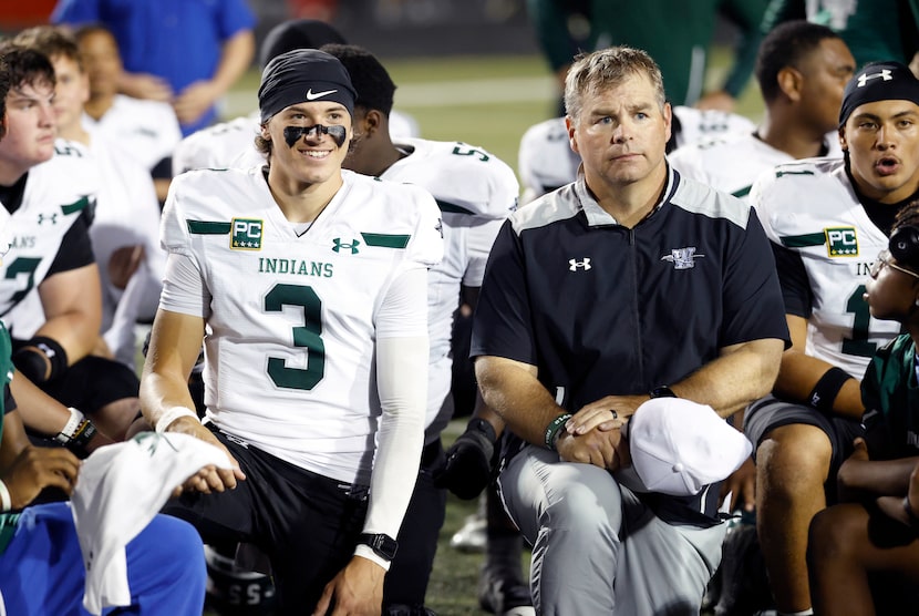 Waxahachie quarterback Jerry Meyer III (3) and his head coach Shane Tolleson take a knee to...
