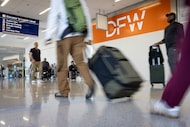 Airline travelers exit baggage claim in Terminal E at DFW International Airport on Sept. 11,...