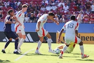 FC Dallas forward Petar Musa (center) touches the ball for a goal against the Los Angeles...