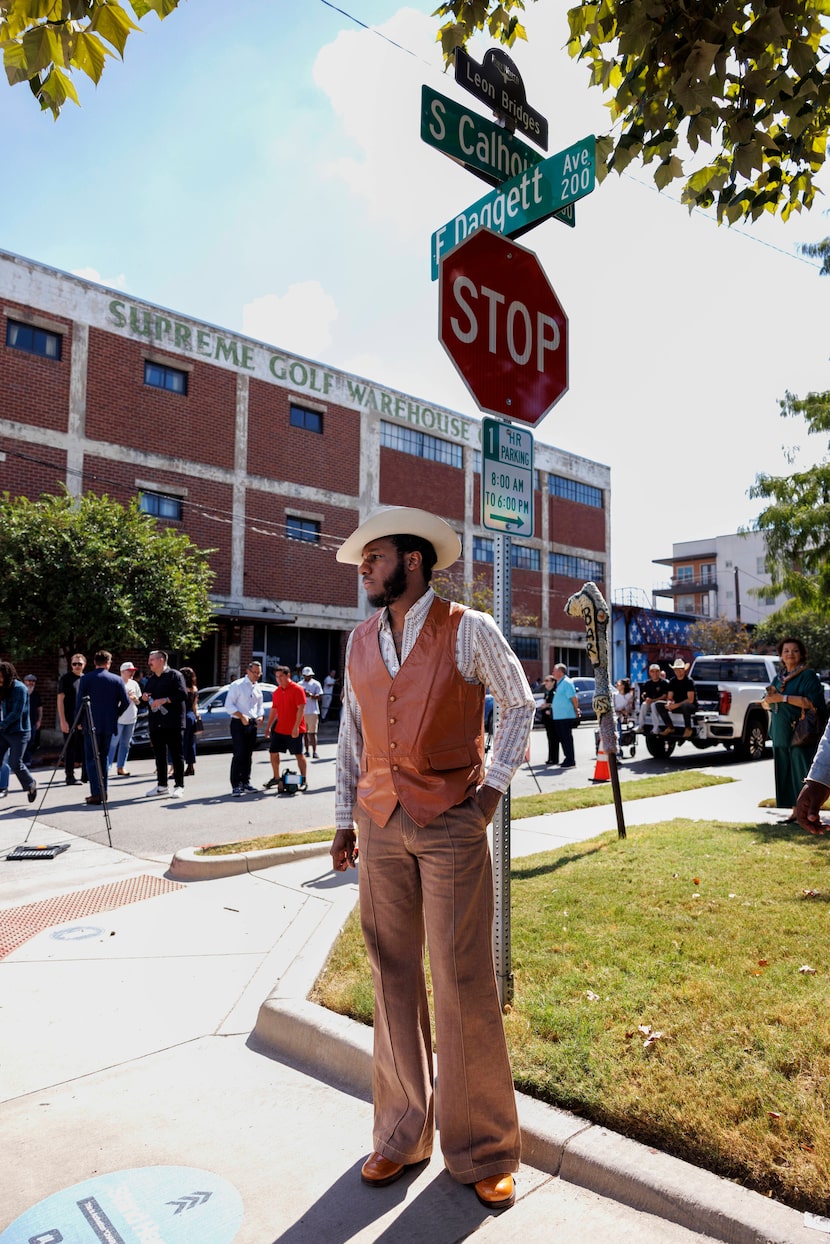 Fort Worth musician Leon Bridges stands in front of a street sign honoring him during a...