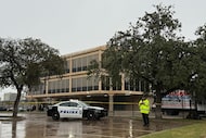 Law enforcement gathers outside a law office following a shooting at the Dallas Immigration...