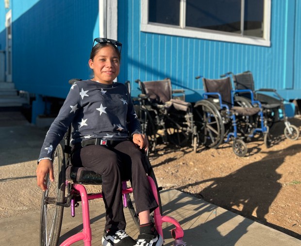 Melina smiling in a chair. (Bradley Heintz)