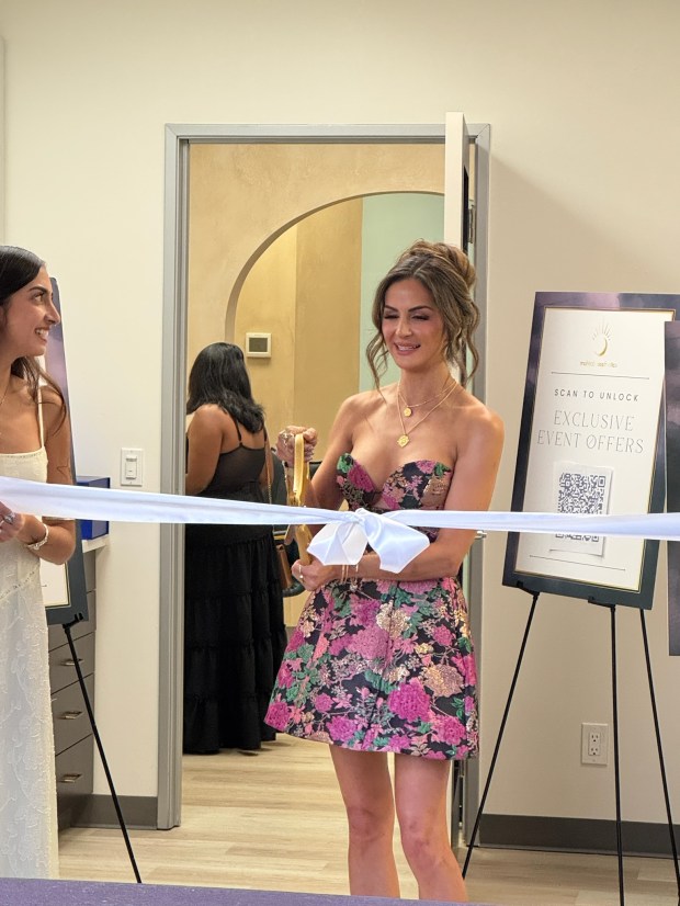 Mena Mesdaq cuts the ribbon at the Grand Opening event....