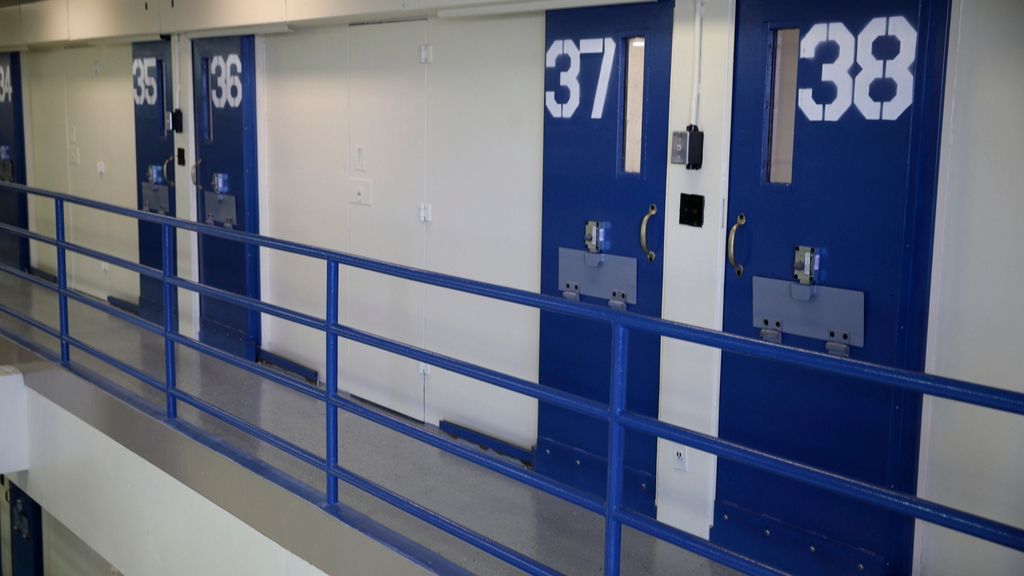 solitary confinement cells with blue doors in a prison