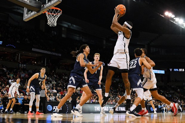 SDSU guard Reese Waters (14) shoots against Yale forward Casey Simmons during the 2024 NCAA Tournament in Spokane, Wash. (Meg McLaughlin / The San Diego Union-Tribune)