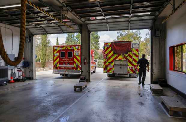 Engineer Joe Harlin walks across the apparatus floor at North County Fire Protection District's Station 4. (Charlie Neuman / For The San Diego Union-Tribune)