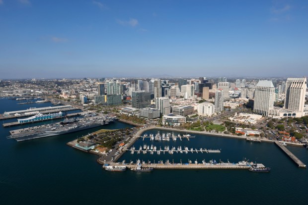In an aerial photo, Tuna Harbor, Seaport Village, the USS Midway Museum, Research and Development District (RaDD), left, and downtown are seen along San Diego Bay on Oct. 7, 2025 in San Diego, CA. (K.C. Alfred / The San Diego Union-Tribune)