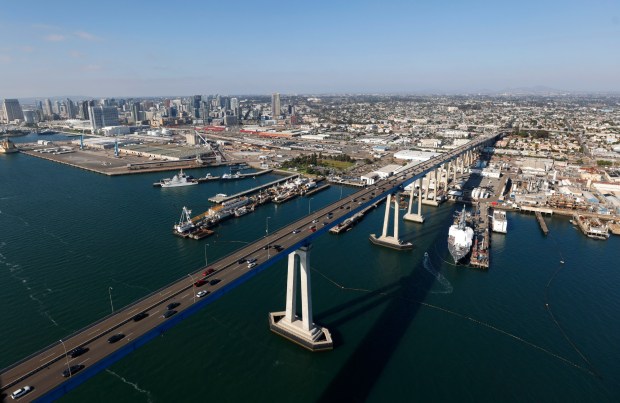 In an aerial photo, the San Diego-Coronado Bridge is seen over San Diego Bay heading into the community of Barrio Logan on Oct. 7, 2025 in San Diego, CA. (K.C. Alfred / The San Diego Union-Tribune)