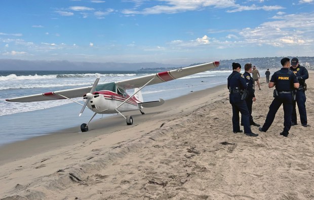 A Cessna made an emergency landing at Mission Beach on Tuesday, Oct. 21, 2025.   The two people onboard were not injured, officials said. (K.C. Alfred / The San Diego Union-Tribune)
