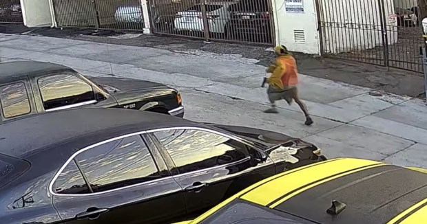 Security camera footage released Friday shows what appears to be a handgun in the left hand of Huy Ly, 41, as he runs from police in the Colina del Sol neighborhood near Fay Elementary on Sept. 23, 2025. (San Diego Police Department)
