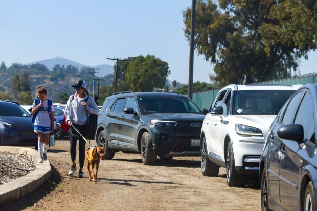 People walk to their cars at Surf Sports Park on Saturday, Oct. 25, 2025. (Meg McLaughlin / The San Diego Union-Tribune)