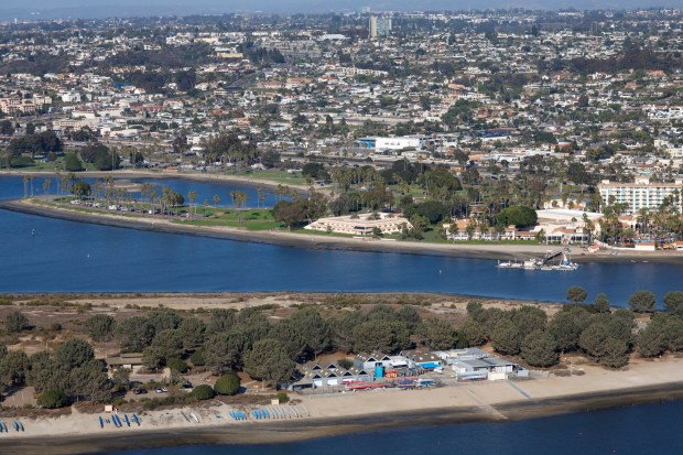 In an aerial photo, the Scouting America Camp Fiesta Island, bottom, and the San Diego Mission Bay Resort, are seen with the communities of Bay Park and Clairemont in the background on Oct. 7, 2025 in San Diego, CA. (K.C. Alfred / The San Diego Union-Tribune)