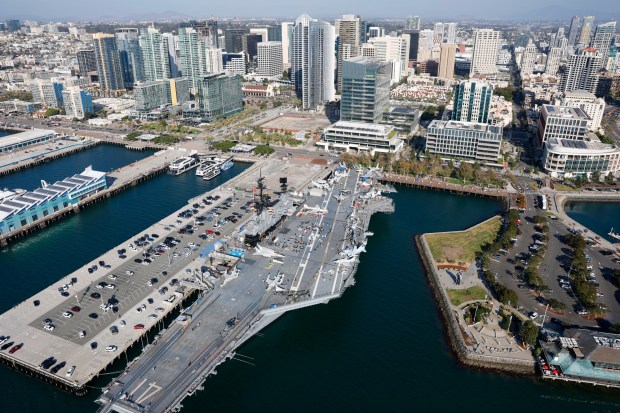 In an aerial photo, the USS Midway Museumare and downtown is seen along San Diego Bay on Oct. 7, 2025 in San Diego, CA. (K.C. Alfred / The San Diego Union-Tribune)