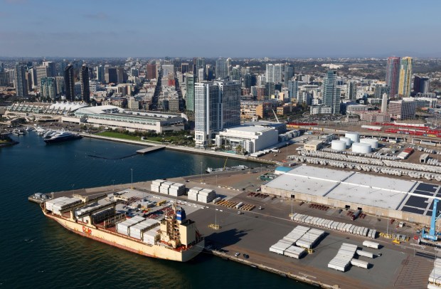In an aerial photo, a Dole container ship is docked at the 10th Avenue Marine Terminal, with the San Diego Convention Center and downtown in the background on Oct. 7, 2025 in San Diego, CA. (K.C. Alfred / The San Diego Union-Tribune)