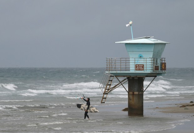 A kiteboarder comes in at San Elijo State Beach Tuesday in Encinitas. (K.C. Alfred / The San Diego Union-Tribune)