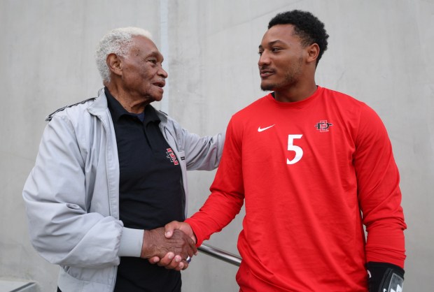 After spending a few minutes together in the Snapdragon Stadium stands, San Diego State quarterback Bert Emanuel Jr. shakes hands with his great-grandfather Bert Robinson Sr. before the Aztecs' game against Colorado State. (Hayne Palmour IV / For The San Diego Union-Tribune)