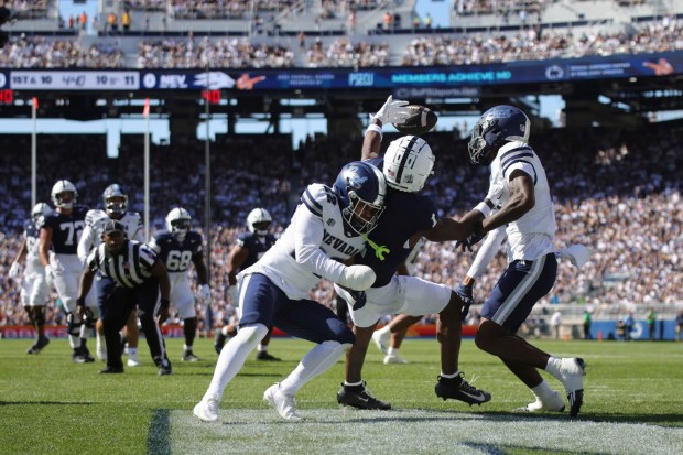 Nevada defensive back Hayden McDonald (22) and defensive back Edward Rhambo (4) break up a pass intended for Penn State wide receiver Kyron Hudson (1) during the first quarter of an NCAA college football game, Saturday, Aug. 30, 2025, in State College, Pa. (AP Photo/Jared Freed)