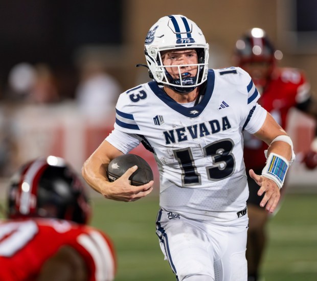 Nevada quarterback Chubba Purdy (13) evades tacklers while scrambling for yardage during an NCAA football game between Western Kentucky University and the University of Nevada, Reno on Saturday, Sept. 20, 2025, in Bowling Green, Ky. WKU beat Nevada 31-16. (AP Photo/James Kenney)