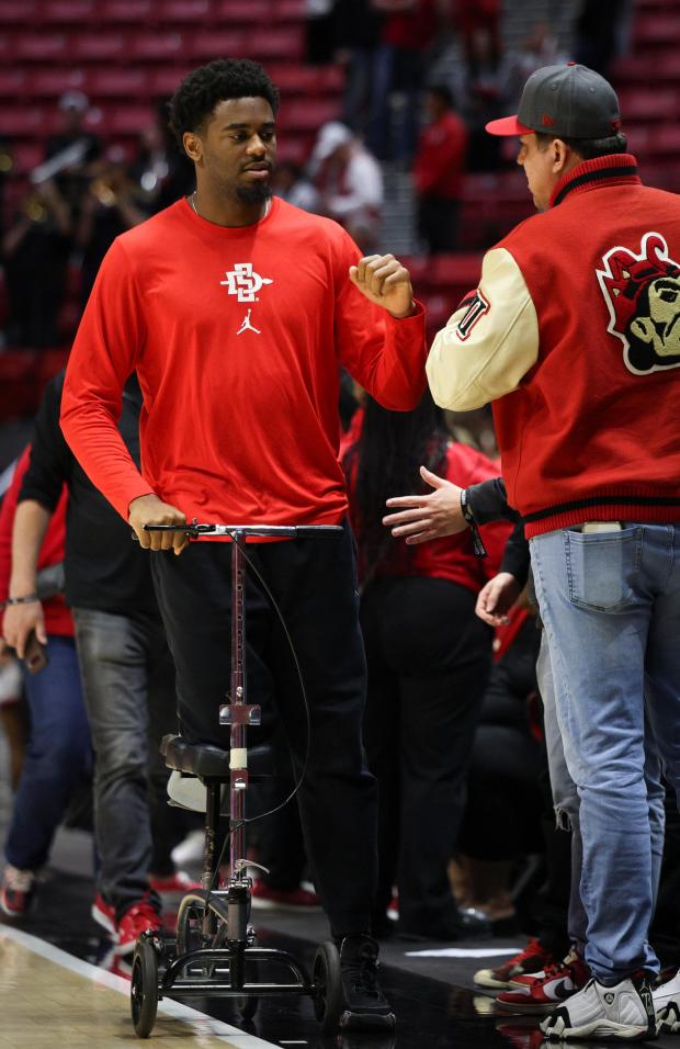 SDSU senior Reese Waters greets fans after their game against USD at Viejas Arena Dec. 7. (Meg McLaughlin / The San Diego Union-Tribune)