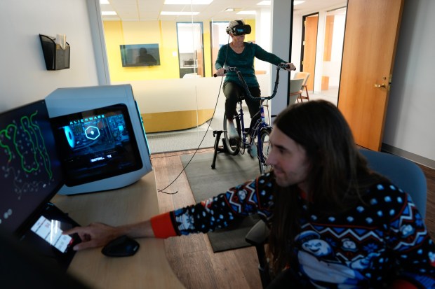 Roxanne Hoffert, 66, is participates in the Brain Research Health Study at UCSD on Tuesday, Oct. 21, 2025, in San Diego, CA.  Hoffert takes a VR tour riding a stationary bicycle 3 times a week for the next 16 weeks, lasting close to 30 minutes on each tour. (Nelvin C. Cepeda / The San Diego Union-Tribune)