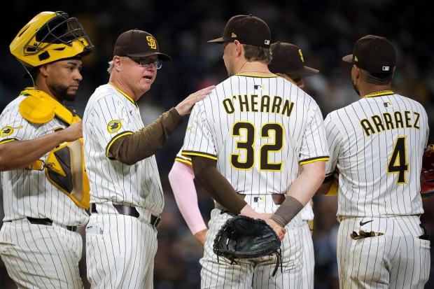 Mike Shildt #8 talks to Ryan O'Hearn #32 of the San Diego Padres during a pitching change in the eighth inning against the Colorado Rockies at Petco Park on Saturday, Sept. 13, 2025 in San Diego, California. (Meg McLaughlin / The San Diego Union-Tribune)