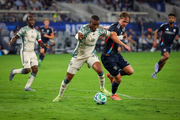 Juan David Mosquera #29 of the Portland Timbers and Onni Valakari #8 of San Diego FC battle for control of the ball during match one of the Western Conference Round One of the 2025 MLS Cup Playoffs at Snapdragon Stadium on Sunday, Oct. 26, 2025 in San Diego, California. (Meg McLaughlin / The San Diego Union-Tribune)
