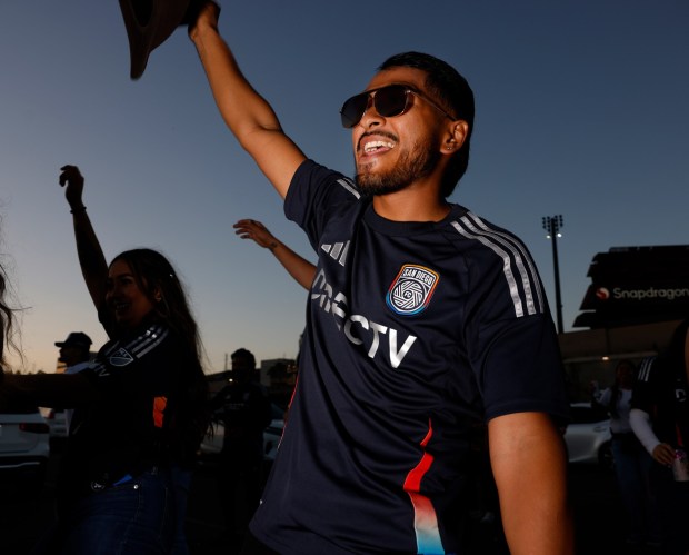 Fan Jordi Lozado dances in the parking lot before the San Diego FC played against the Portland Timbers in match one of the Western Conference Round One of the 2025 MLS Cup Playoffs at Snapdragon Stadium on Oct. 26, 2025 in San Diego, California. (Photo by K.C. Alfred / The San Diego Union-Tribune)