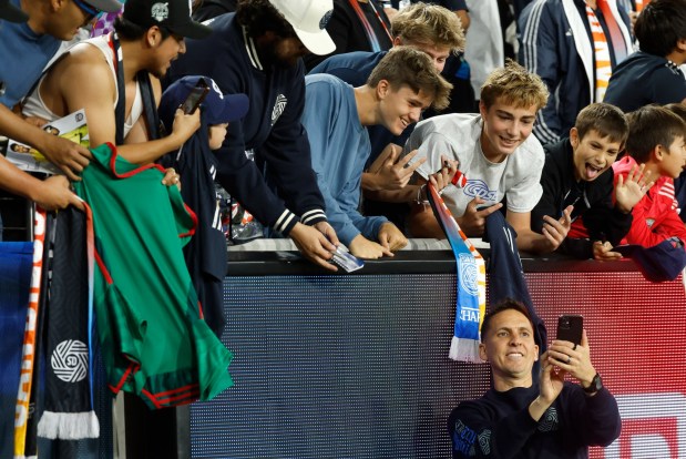 San Diego FC coach Mikey Varas takes photos with fans after a 2-1 win against the Portland Timbers in match one of the Western Conference Round One of the 2025 MLS Cup Playoffs at Snapdragon Stadium on Oct. 26, 2025 in San Diego, California. (K.C. Alfred / The San Diego Union-Tribune)
