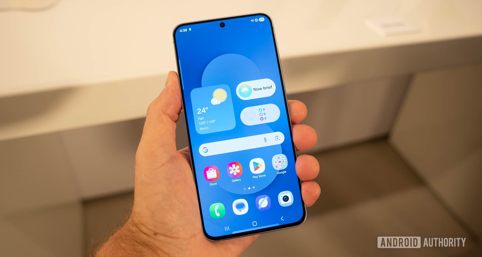 Samsung Galaxy S25 FE in man's hand showing home screen