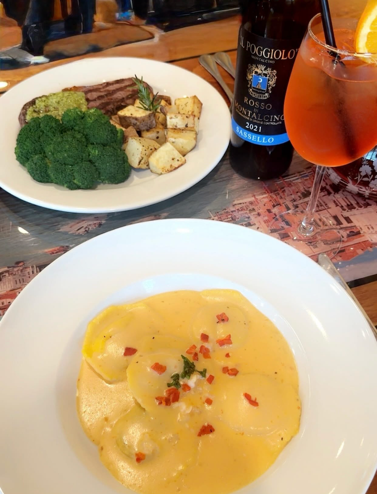 Pasta dish wine bottle and steak with potatoes at Casa Mia.