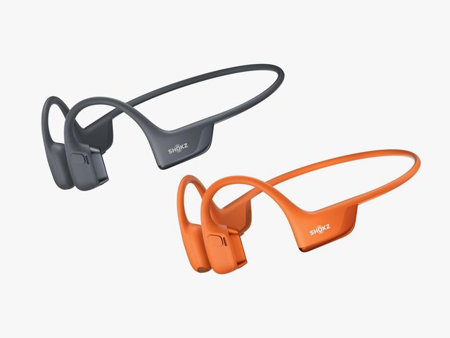 Two headphones that wrap around the back of the head, in black and orange