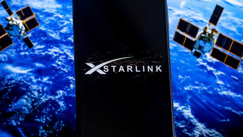 Starlink logo on a screen with planet and satellites in background