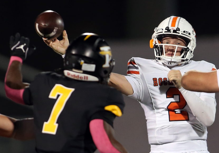 Rockwall quarterback Brent Rickert (2), launches a pass beyond the defensive pressure of...