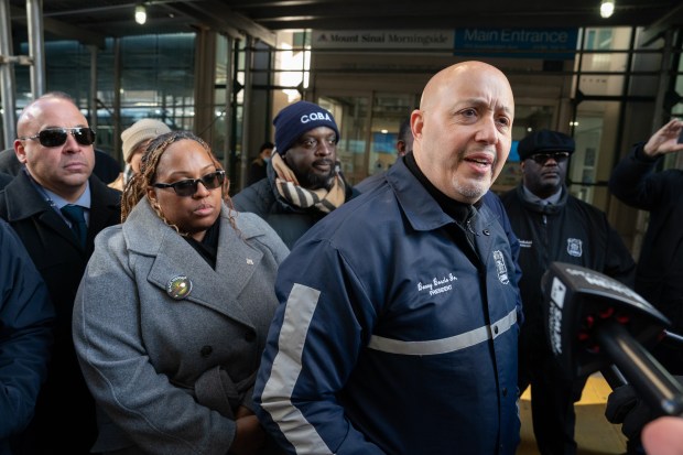 Benny Boscio (right), president of the Correction Officers Benevolent Association, looks on in February as NYCDOC officer Shamika Mitchell leaves Mt. Sinai Morningside hospital.
