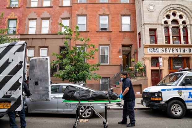 Medical Examiner workers remove the body of Jacob Zieben, 34, from his home on W. 138th St. in Manhattan on Aug. 1.
