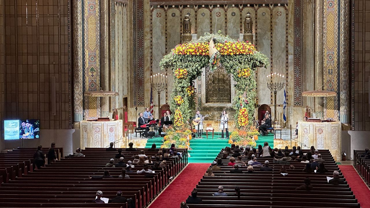 Monday’s procession coincides with the Jewish holiday Simchat Torah — a joyous milestone during which the Torah reading cycle concludes and starts again. (Spectrum News NY1/Rebecca Greenberg)