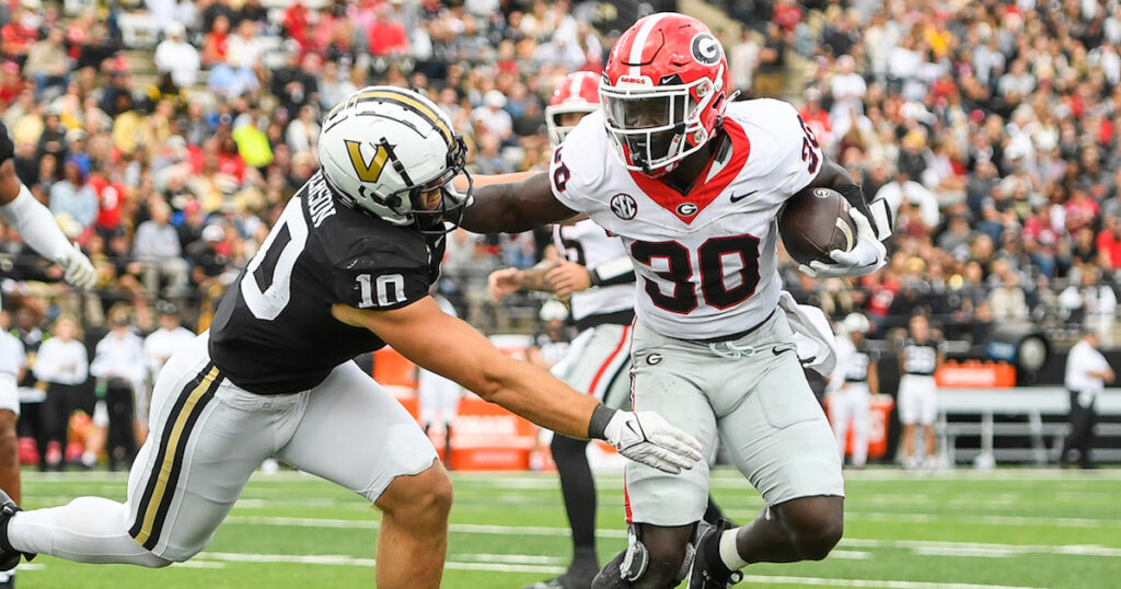 Georgia Bulldogs running back Daijun Edwards stiff arms Vanderbilt Commodores linebacker Langston Patterson