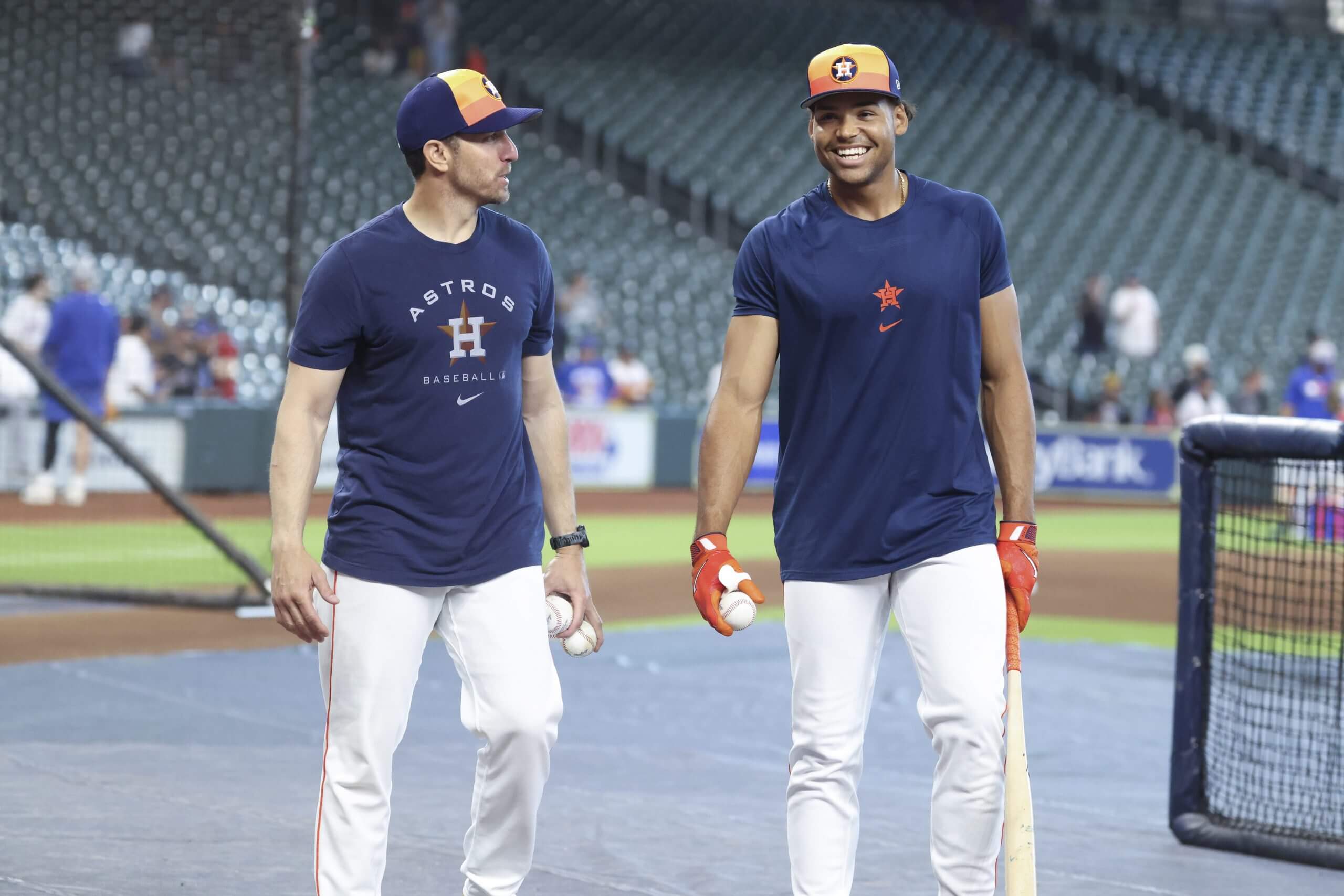Troy Snitker and Cam Smith chat near the Daikin Park batting cage.