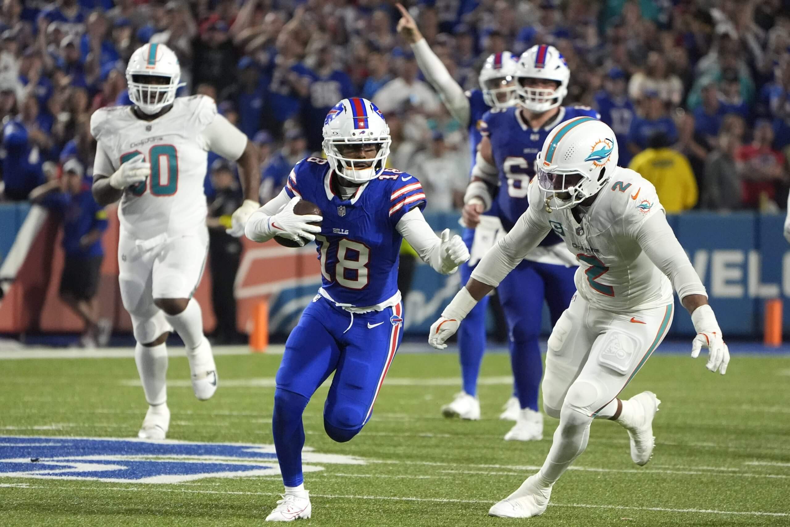 Buffalo Bills wide receiver Elijah Moore (18) runs against Miami Dolphins outside linebacker Bradley Chubb (2) in the fourth quarter at Highmark Stadium.