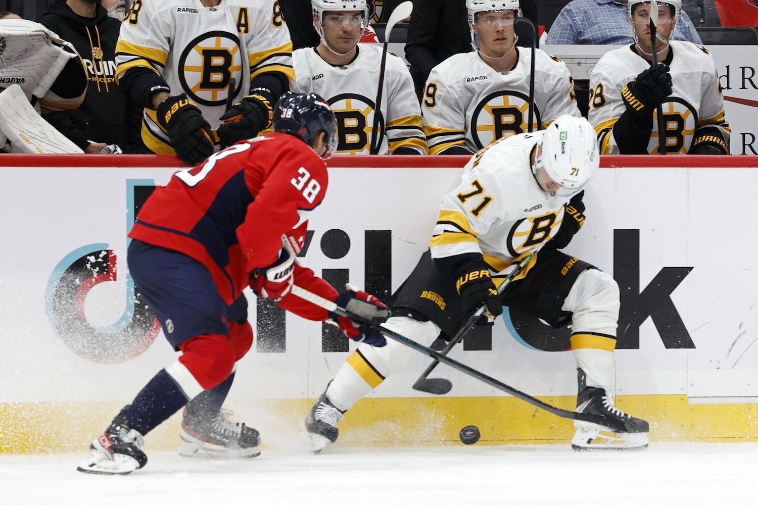Oct 8, 2025; Washington, District of Columbia, USA; Boston Bruins left wing Viktor Arvidsson (71) and Washington Capitals defenseman Rasmus Sandin (38) battle for the puck during the second period at Capital One Arena. Mandatory Credit: Geoff Burke-Imagn Images