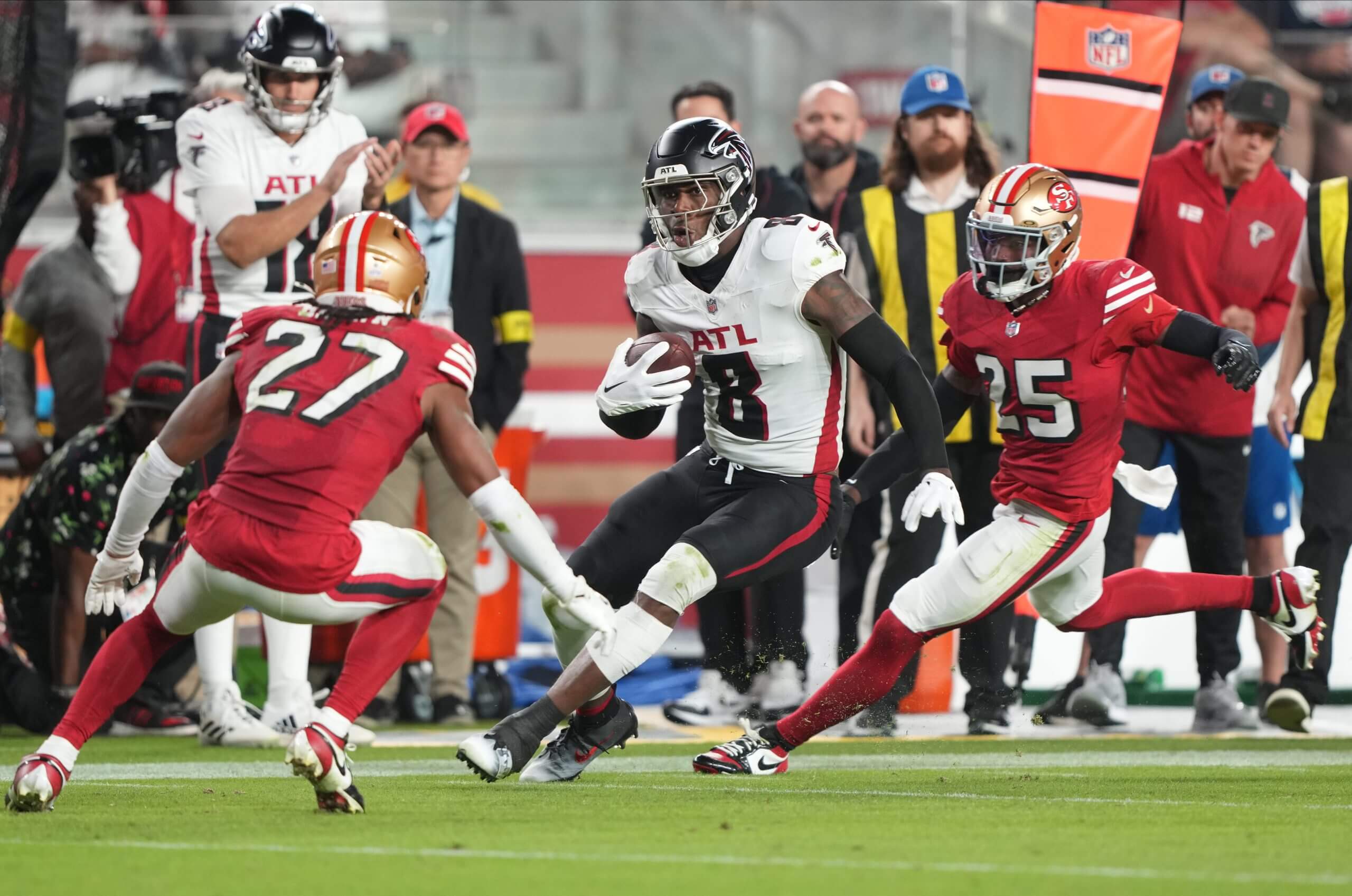 Atlanta Falcons tight end Kyle Pitts (8) runs after a catch against San Francisco 49ers safety Ji'Ayir Brown (27) and San Francisco 49ers safety Jason Pinnock (25) during the third quarter at Levi's Stadium.
