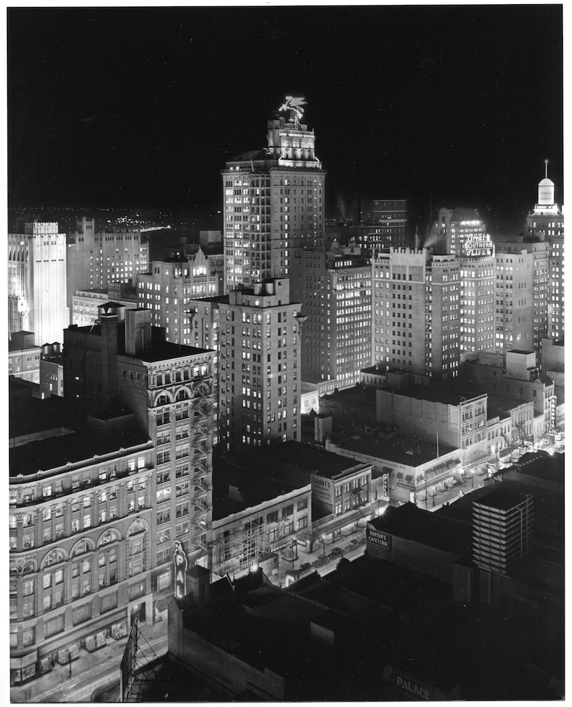 A Dallas Historical Society photo by Lloyd Long is a dramatic night view of downtown Dallas...