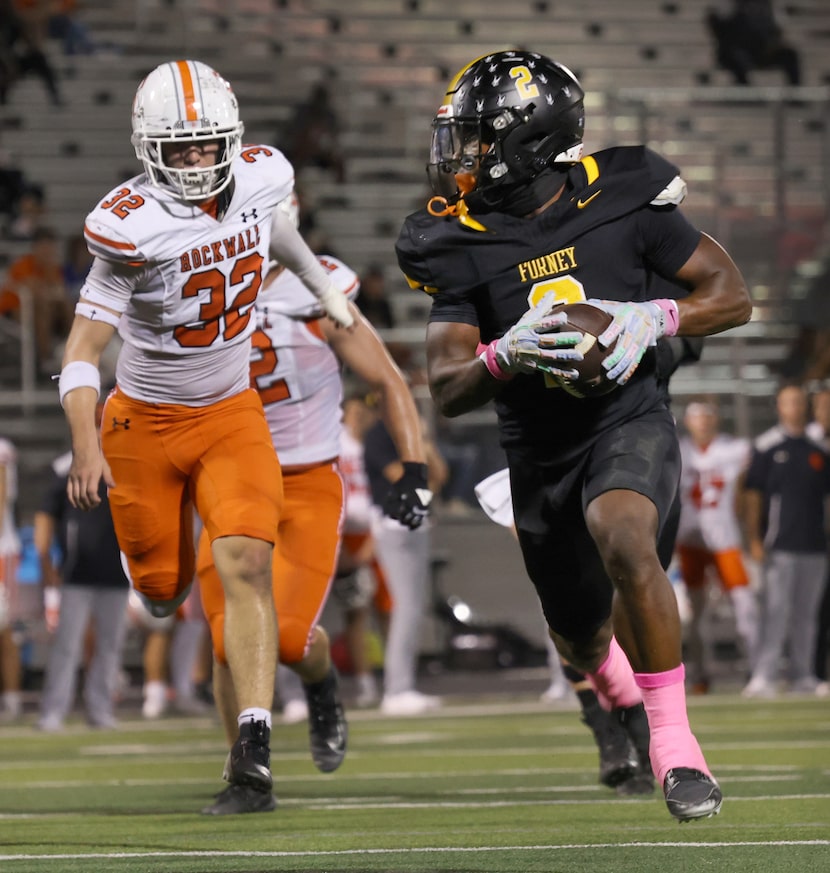 Forney running back Javian Osborne (2), right, sprints to the end zone as he is pursued...