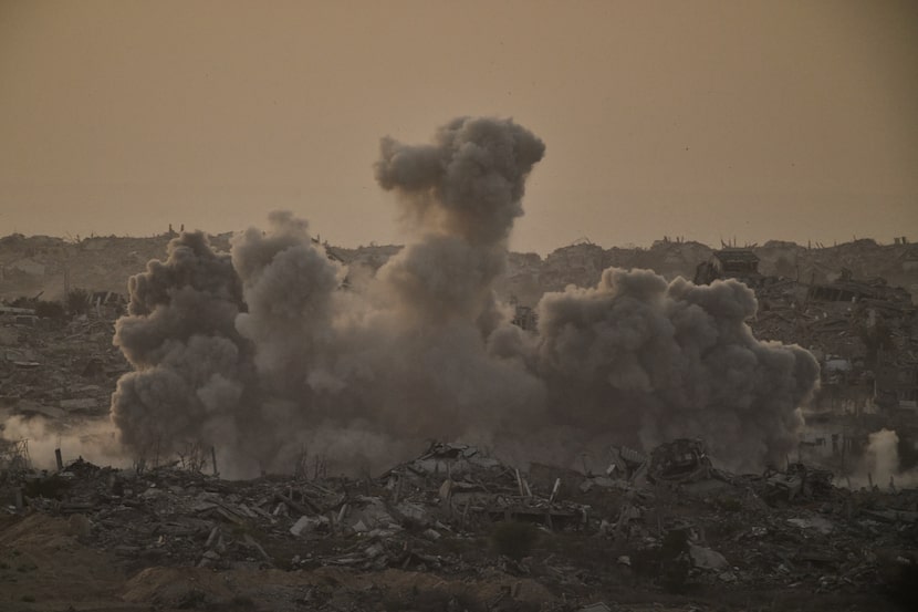 Buildings that were destroyed during the Israeli ground and air operations are engulfed by...